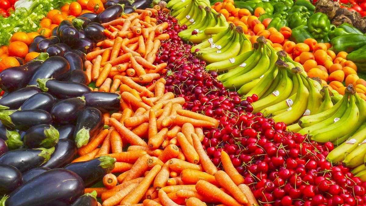 Vibrant selection of fresh fruits and vegetables on a market stall. Healthy eating and organic living.